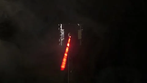 A red SciFi laser beam shining through smoke Stock Footage 340405482