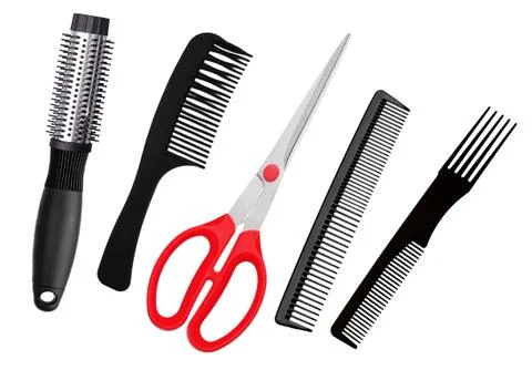 Red scissors and combs isolated on white Stock Photos