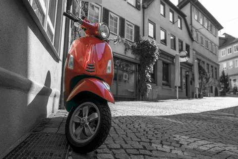 Red scooter on medieval town empty street Stock Photos