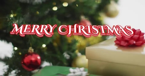 Red script sliding in starting greeting over gifts, camera shifting revealing Stock Footage 321318990