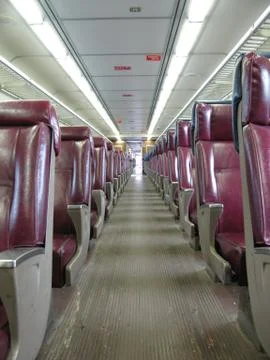 Red seats of an empty passenger train Stock Photos