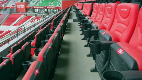 Red seats on tribune overlooking large swimming pool Stock Footage 231722541