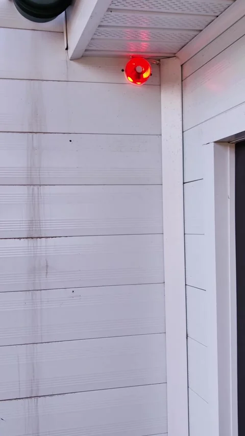 Red security alarm light flashing on house exterior. Stock Footage 328968385