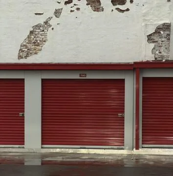 Red Self Storage Unit Doors with Weathered Brick Wall Background Stock Photos
