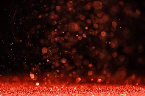 Red sequins fall on a black background Stock Photos