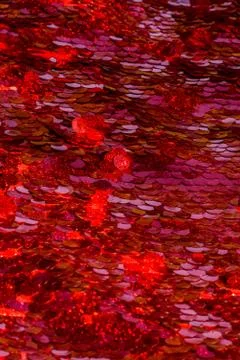 Red sequins pattern. Sparkling sequins background. Red sequin fabric for back Foto stock