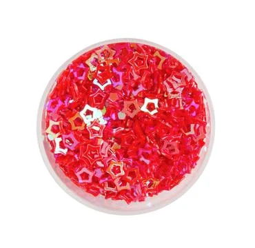 Red sequins in shape of stars on white background, top view Stock Photos