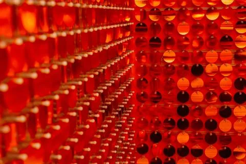 Red sequins on the wall of the house. the texture of round red plastics for.. Stock Photos