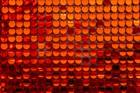Red sequins on the wall of the house. the texture of round red plastics for.. Stock Photos