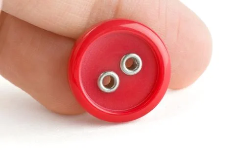 Red sewing button on hand Stock Photos