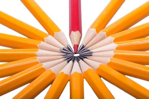 Red sharpened pencil among non sharpened yellow Stock Photos