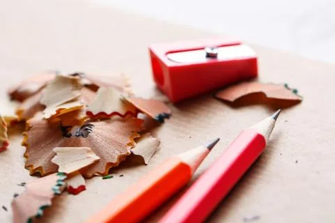 Red sharpener with pencils on the table Stock Photos