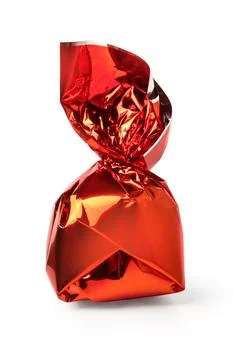 Red shiny candy wrapper containing sweet chocolate treat Stock Photos