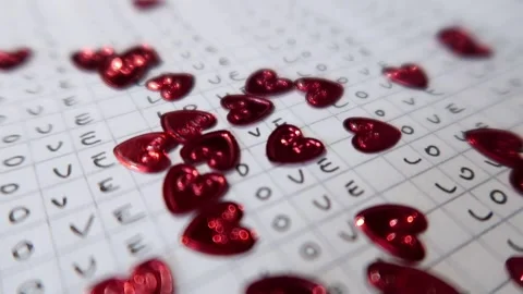Red shiny hearts falling down a notebook page Video stock 161063314