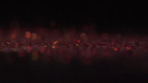 Red shiny sparkles falling on the black background, abstract slow motion Stock Footage 75964567