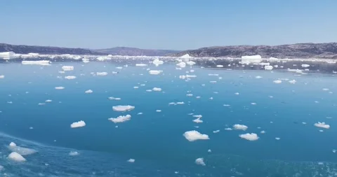 Red ship floating between ice floes at sea Video stock 148198169