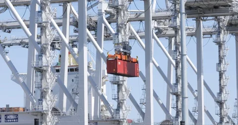 Red Shipping Container Being Lifted Towards Ship Stock Footage 129217648