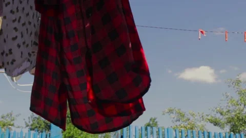 The red shirt in the wind, it's outside drying on the clothesline, copy space Stock Footage 136052006