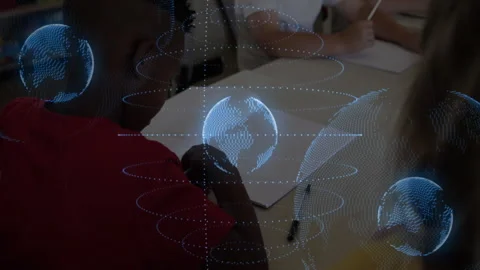 Red-shirted boy raising pen in class initiating holographic globe orbiting over Stock Footage 312083391
