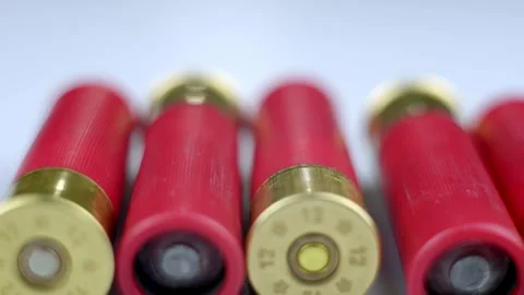 Red shotgun shells on a light surface. Stockbeeldmateriaal 262237658