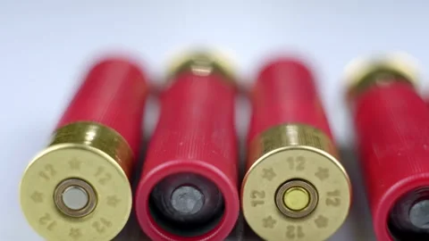 Red shotgun shells on a light surface. Stockbeeldmateriaal 262237670
