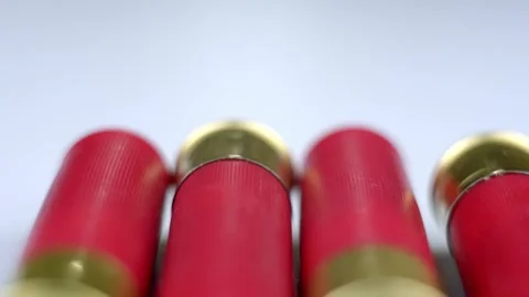Red shotgun shells on a light surface. Stockbeeldmateriaal 262237674