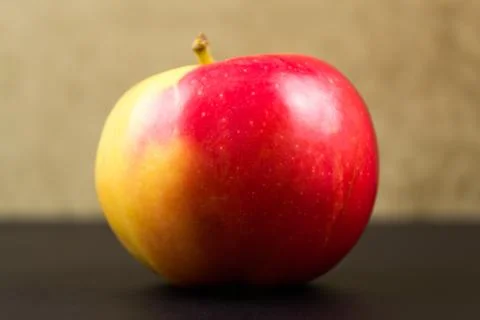 Red-sided apple on a black background Stock Photos
