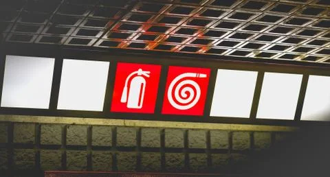 Red sign indicating access to extinguishers and fire ramps Stock Photos