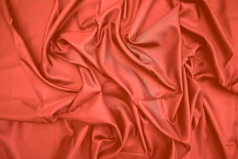 Red silk fabric drapes, studio shot, elegant waves, background blur, textil.. Stock Photos