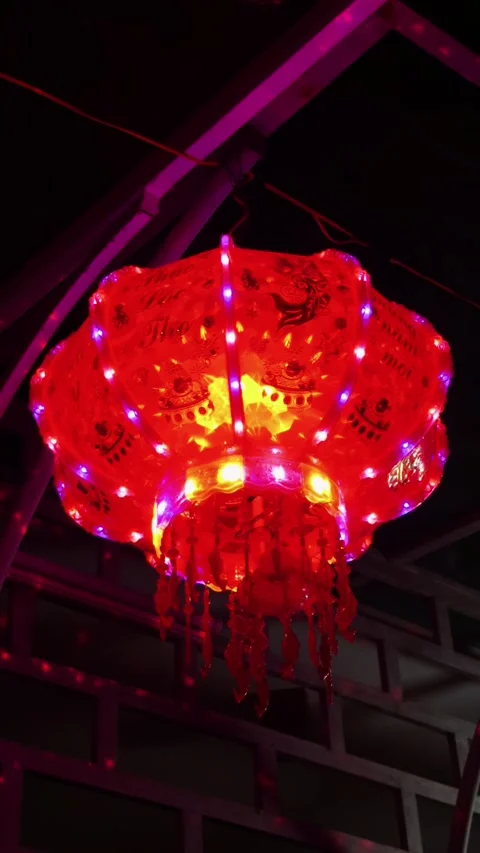 Red silk lantern illuminated with led lights, hanging as a cultural decoration Stock Footage 330115531
