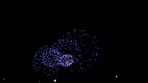 Red silver and blue bright sparks of fireworks on the black sky. General plan Video stock 307439944
