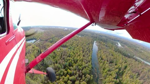 Red Single Engine Airplane Approach and Landing in Alaska Stock Footage 125066945