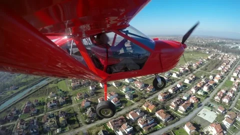 Red single seat propeller airplane approaches runway - Small Airplane and Hobby Stock Footage 340523834