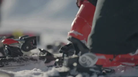 Red ski boot placed into binding 스톡 동영상 346055895