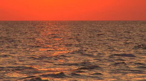 Red sky over a calm ocean Stock Footage 38322352