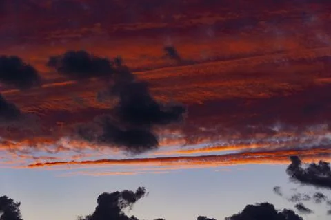 Red sky at sunset with dark clouds Stock Photos