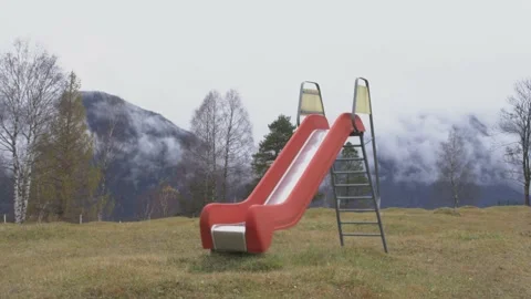 Red slide with Mountains and clouds in the background Stock Footage 220019515