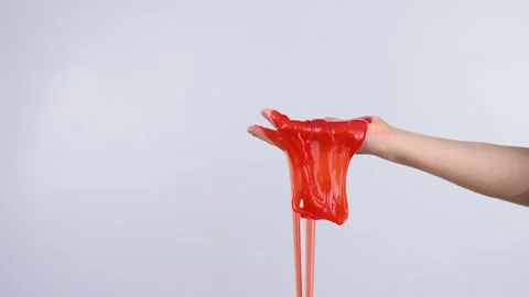 a-little-girl-hands-making-slime-herself-on-blue-wooden-background