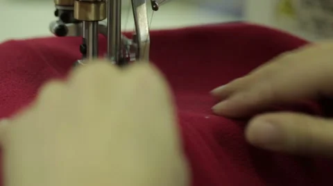Red сlothe sew on the sewing machine Stock Footage 57763893