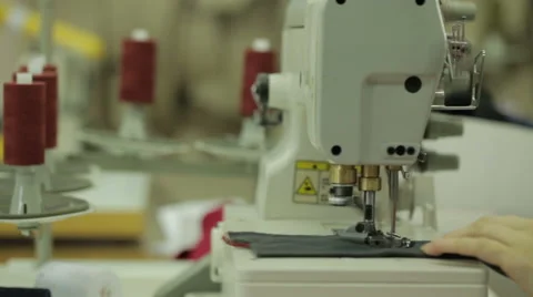 Red сlothe sew on the sewing machine motion Stock Footage 57763920
