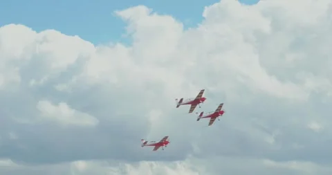 Red small propeller airplanes flying in blue cloudy sky near airport windsock Stock Footage 340206255