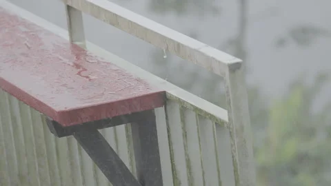 Red Small Table by Fence During Rainy Weather - S Log 3 Stock Footage 306193662