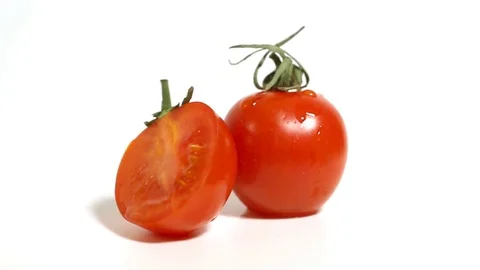 Red small tomatoes rotate on a white background. Stock Footage 101754623