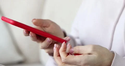 Red smartphone user scrolls feed on screen and spins fidget dice Stock Footage 321575874
