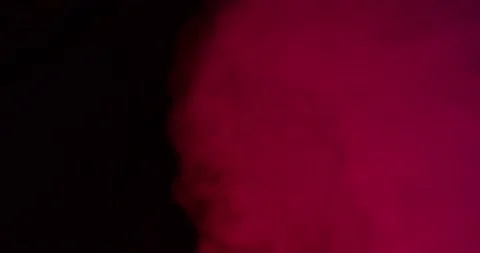 Red smoke on a black background Stock Footage 237884574