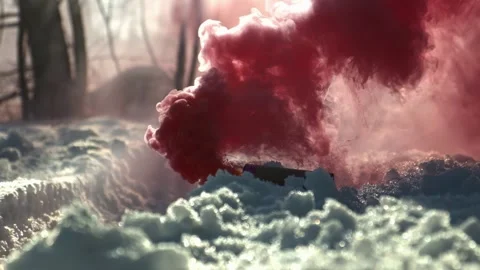 A red smoke bomb is lying on the snow, thick red smoke, slow motion Stock Footage 210036284