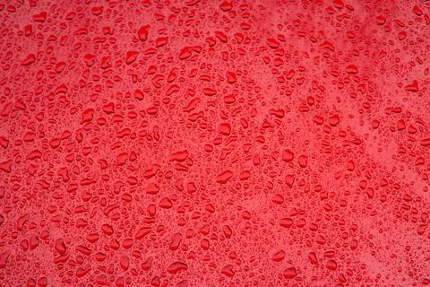 Red smooth background surface with water drops simple pattern concept picture Stock Photos