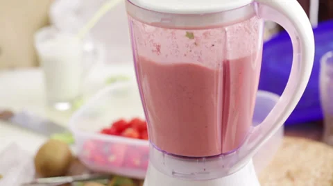 Red smoothie mixing in food processor Stock Footage 35983405