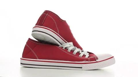 Red sneakers revolve on a white background Stock Footage 50003025