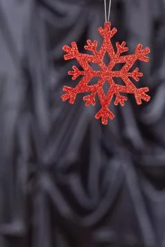 Red snow flake on a black background Foto stock